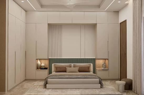 Guest bedroom with panelled headboard wall and integrated niche lighting