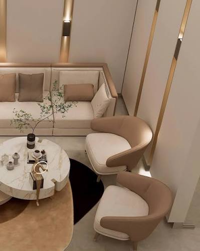 Cosy reading nook with a cream lounge chair, round table and olive branch styling