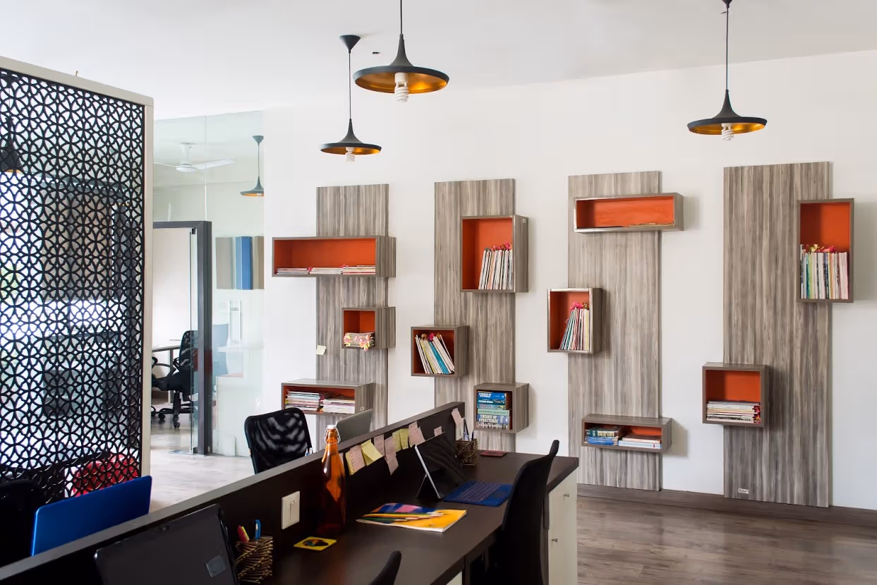 Home study with floating display boxes, a jali screen and warm wood tones